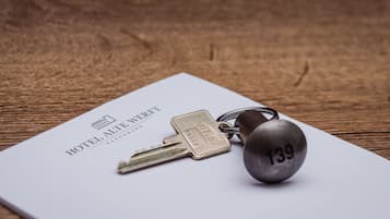 A set of keys and a padlock on a hotel brochure.