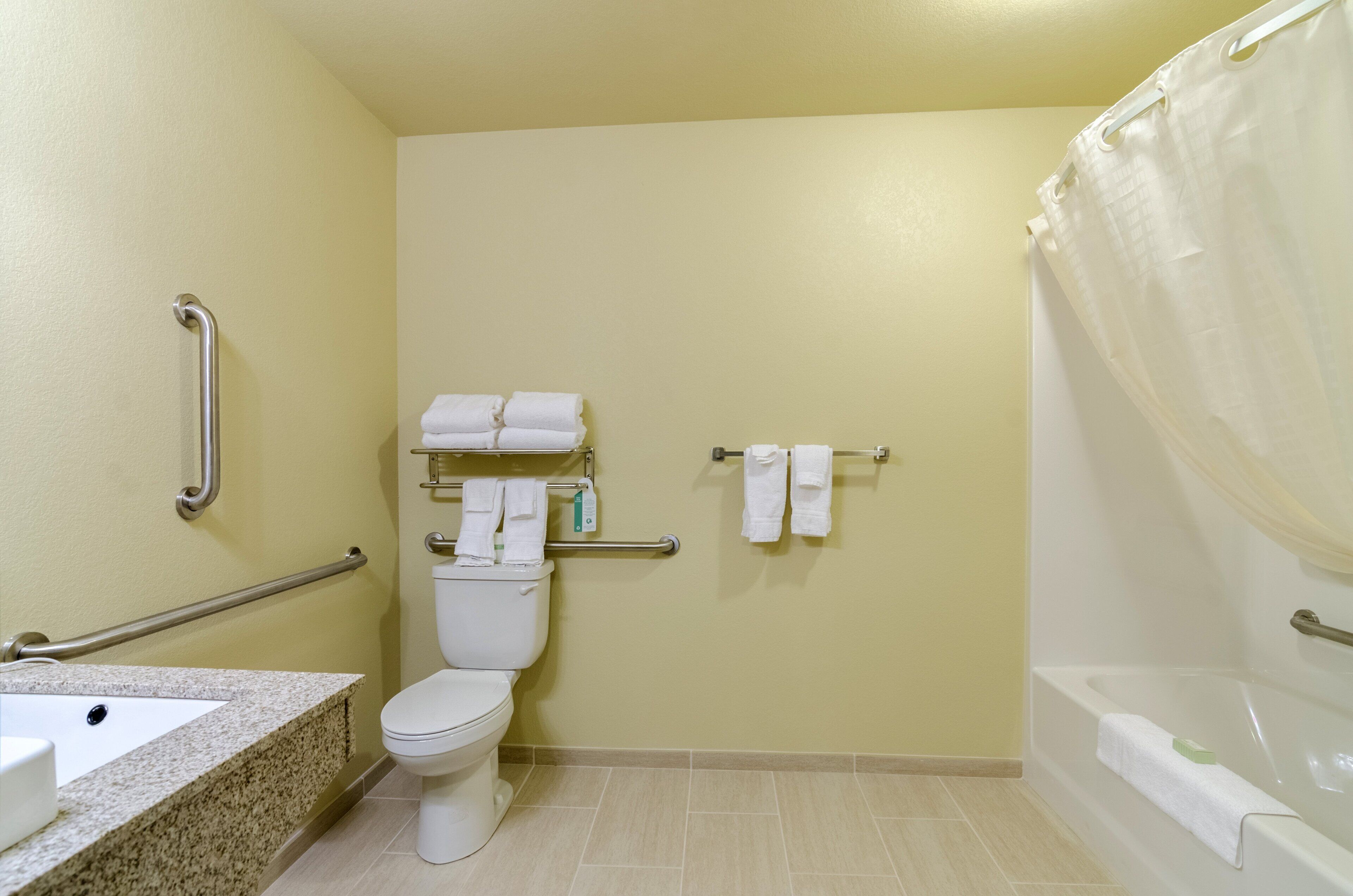 A bathroom with a toilet, sink, and bathtub.
