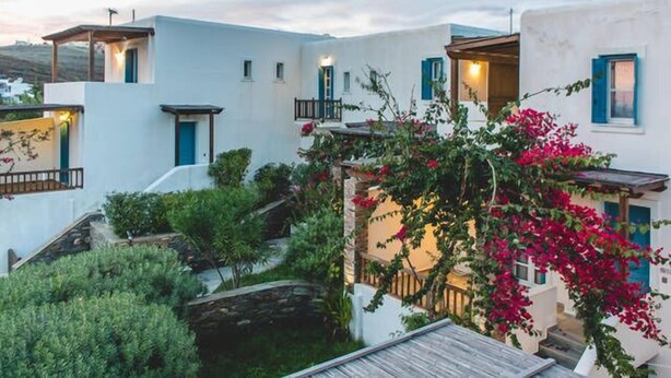 A white building with blue shutters and a small balcony. - Andros Maisonettes (Andros)