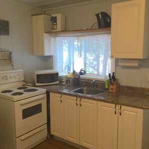 Full-size fridge, microwave, stovetop, coffee/tea maker