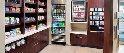 A self-service kiosk with snacks, beverages, and toiletries.