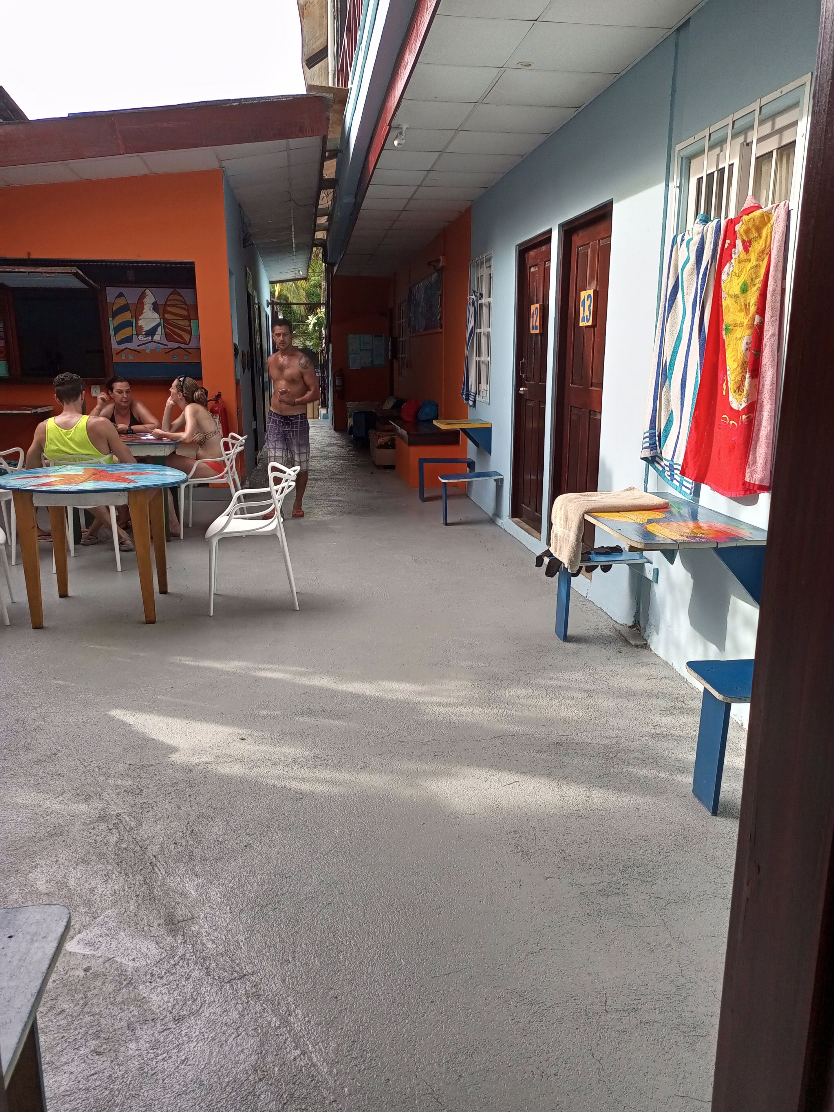 A courtyard with outdoor seating, a small table, and a bench.