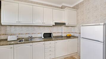 Apartment, 1 Bedroom | Private kitchen | Full-size fridge, microwave, stovetop, coffee/tea maker