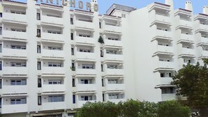 A multi-story residential building with balconies and a clear sky.