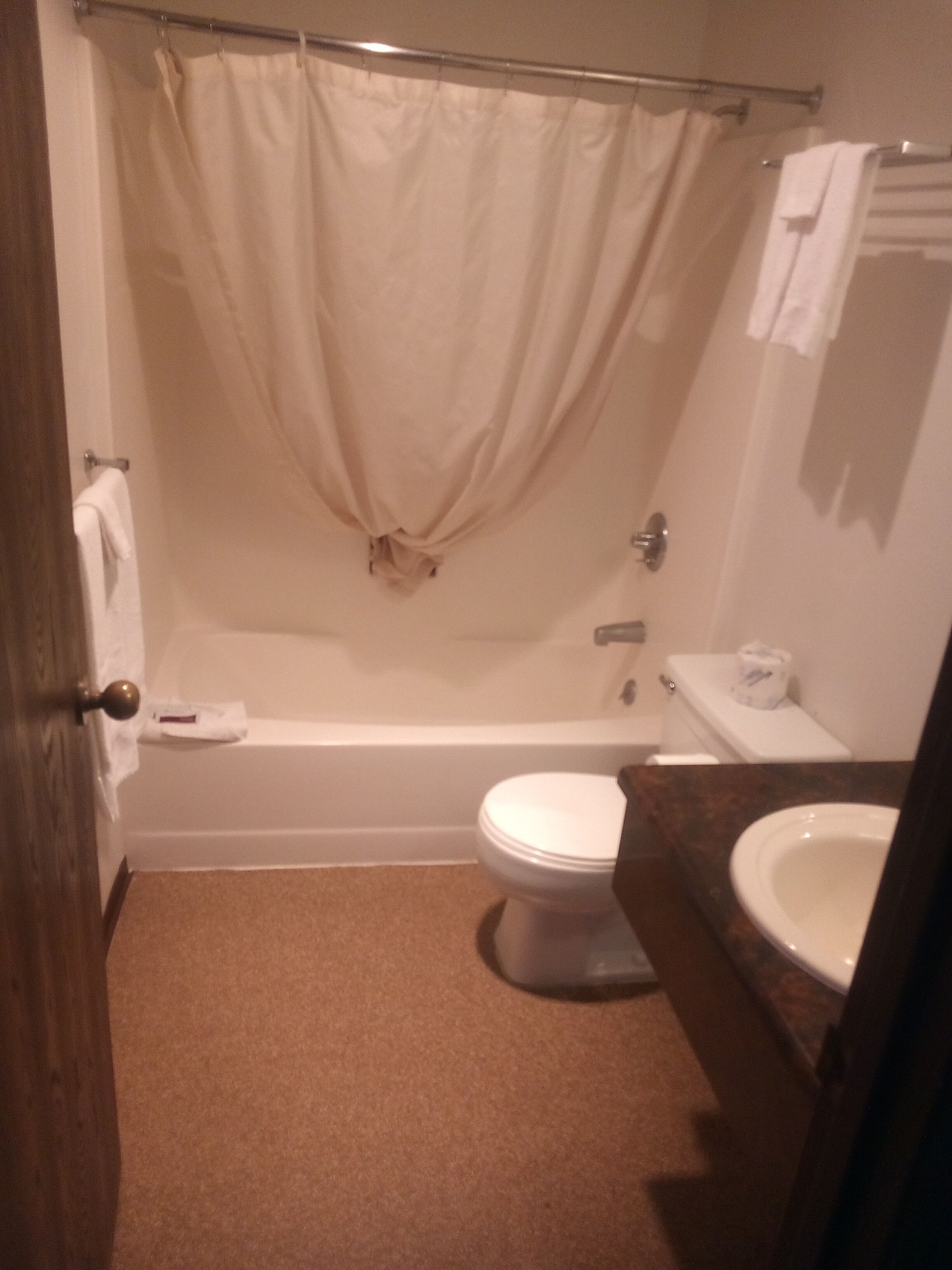 A bathroom with a bathtub, toilet, and sink.