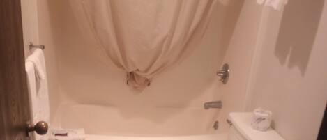 A bathroom with a bathtub, toilet, and sink.