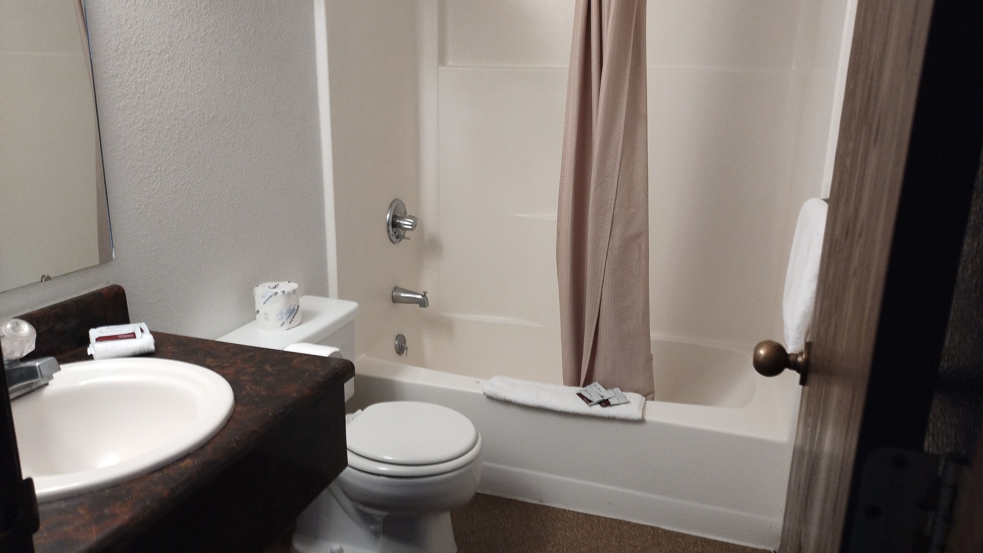 A bathroom with a sink, toilet, and bathtub.
