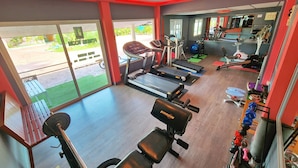 A gym with treadmills, weight machines, and exercise balls. - Phaithong Sotel Resort (Chalong)