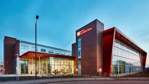 A modern hotel with a prominent glass facade and a red-brick exterior. - Hilton Garden Inn Sunderland (Sunderland)