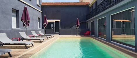 Seasonal outdoor pool, open 9:00 AM to 8:00 PM, pool umbrellas