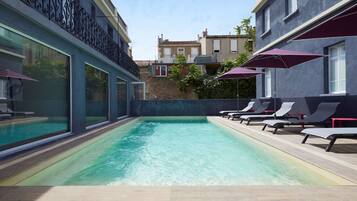 Seasonal outdoor pool, open 9:00 AM to 8:00 PM, pool umbrellas