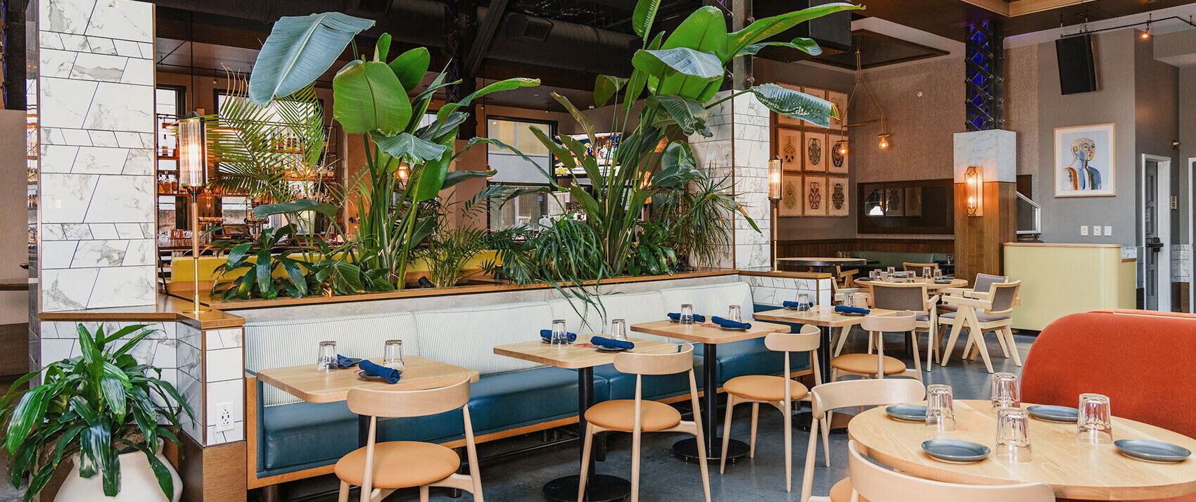 A restaurant interior with booths, tables, and a bar area.