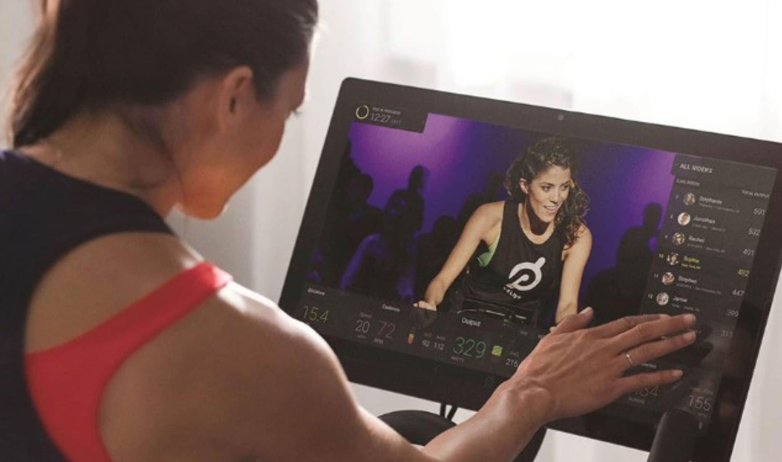 A person using a stationary bike with a digital display.