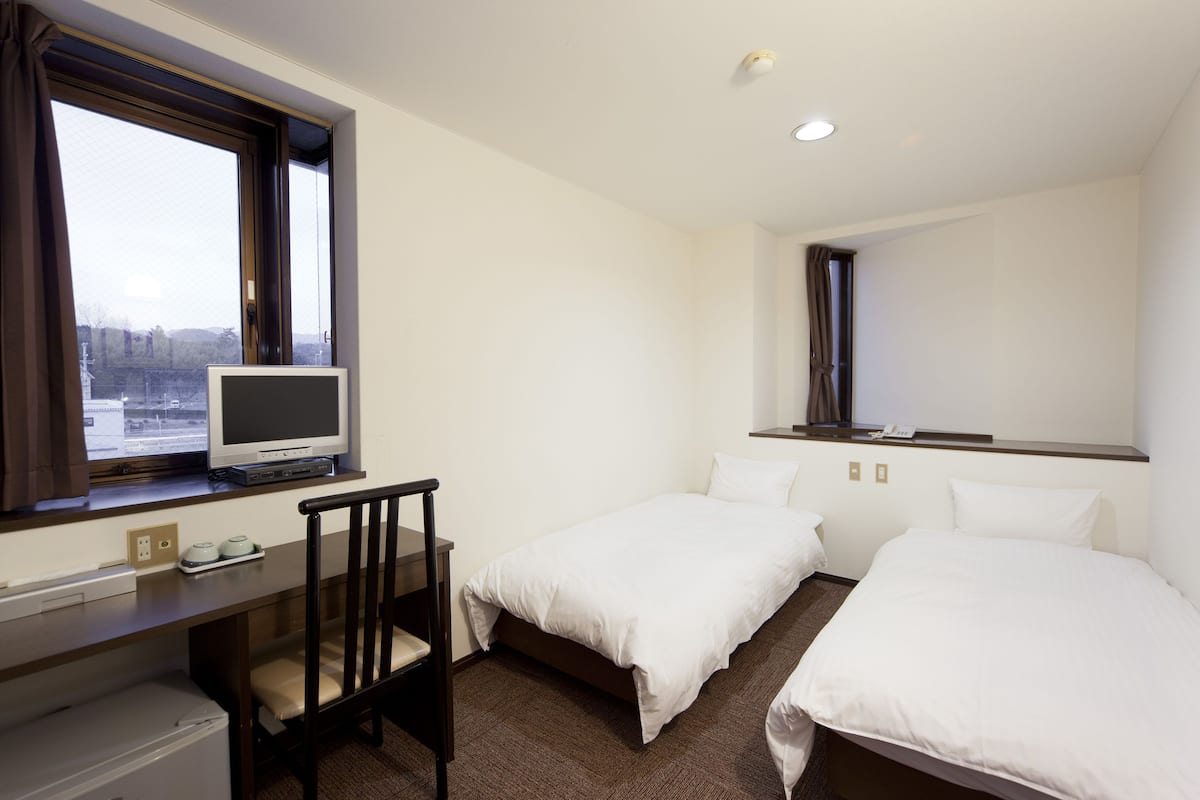 Desk, iron/ironing board, bed sheets