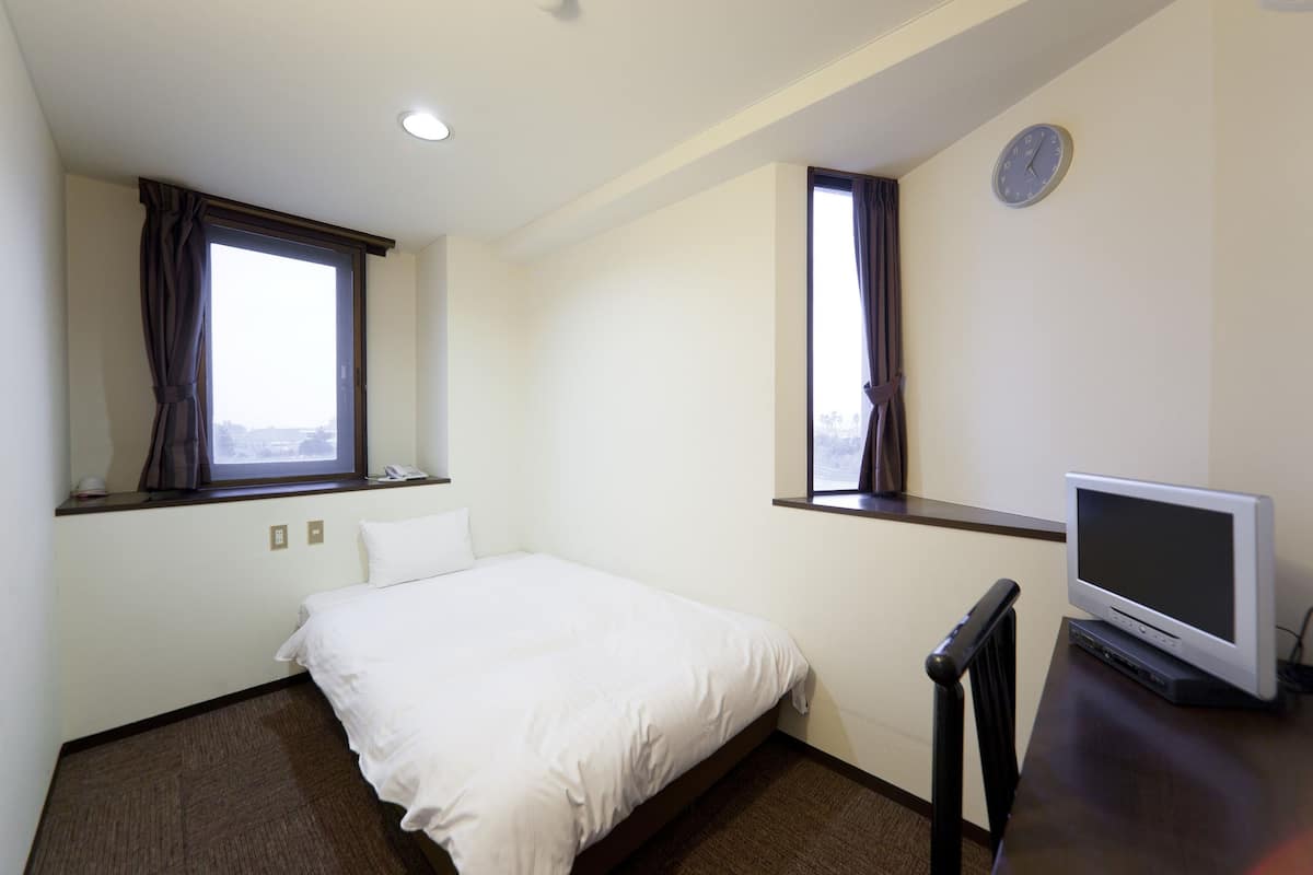 Desk, iron/ironing board, bed sheets