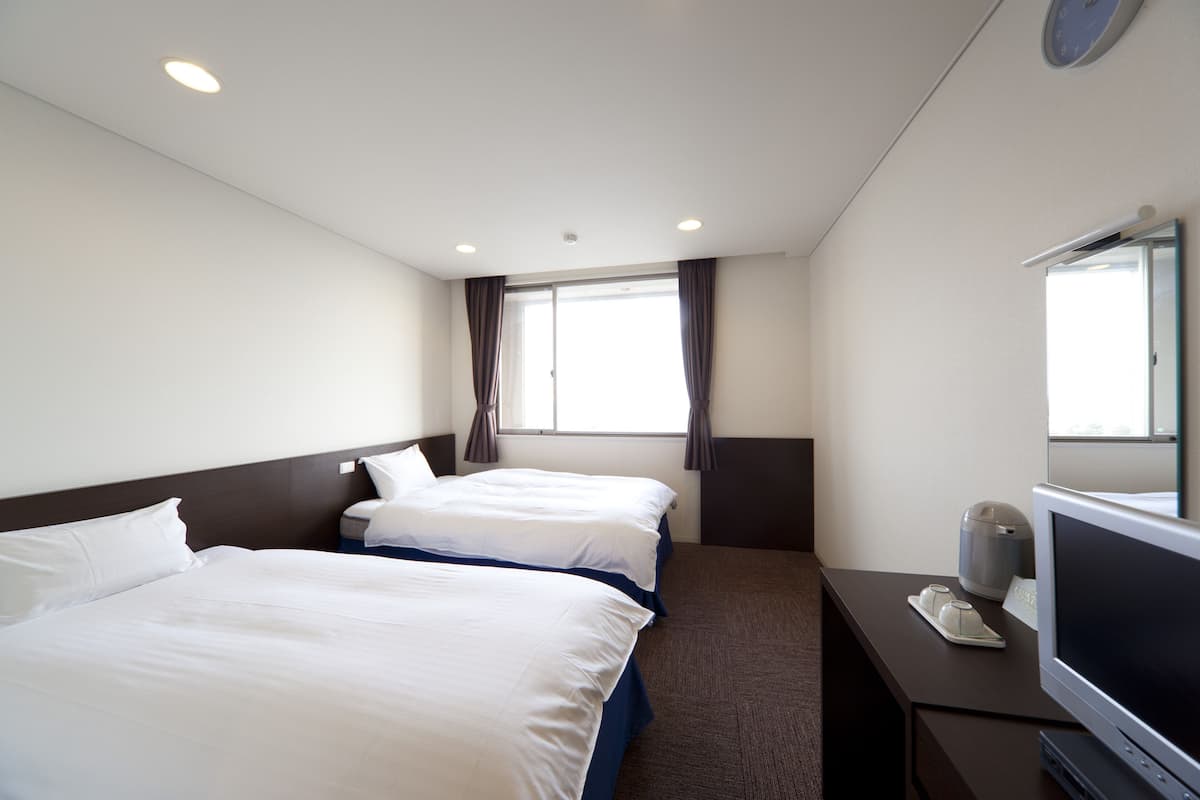 Desk, iron/ironing board, bed sheets
