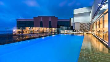 Relax by the pool in a spacious outdoor area with a swimming pool and comfortable seating.