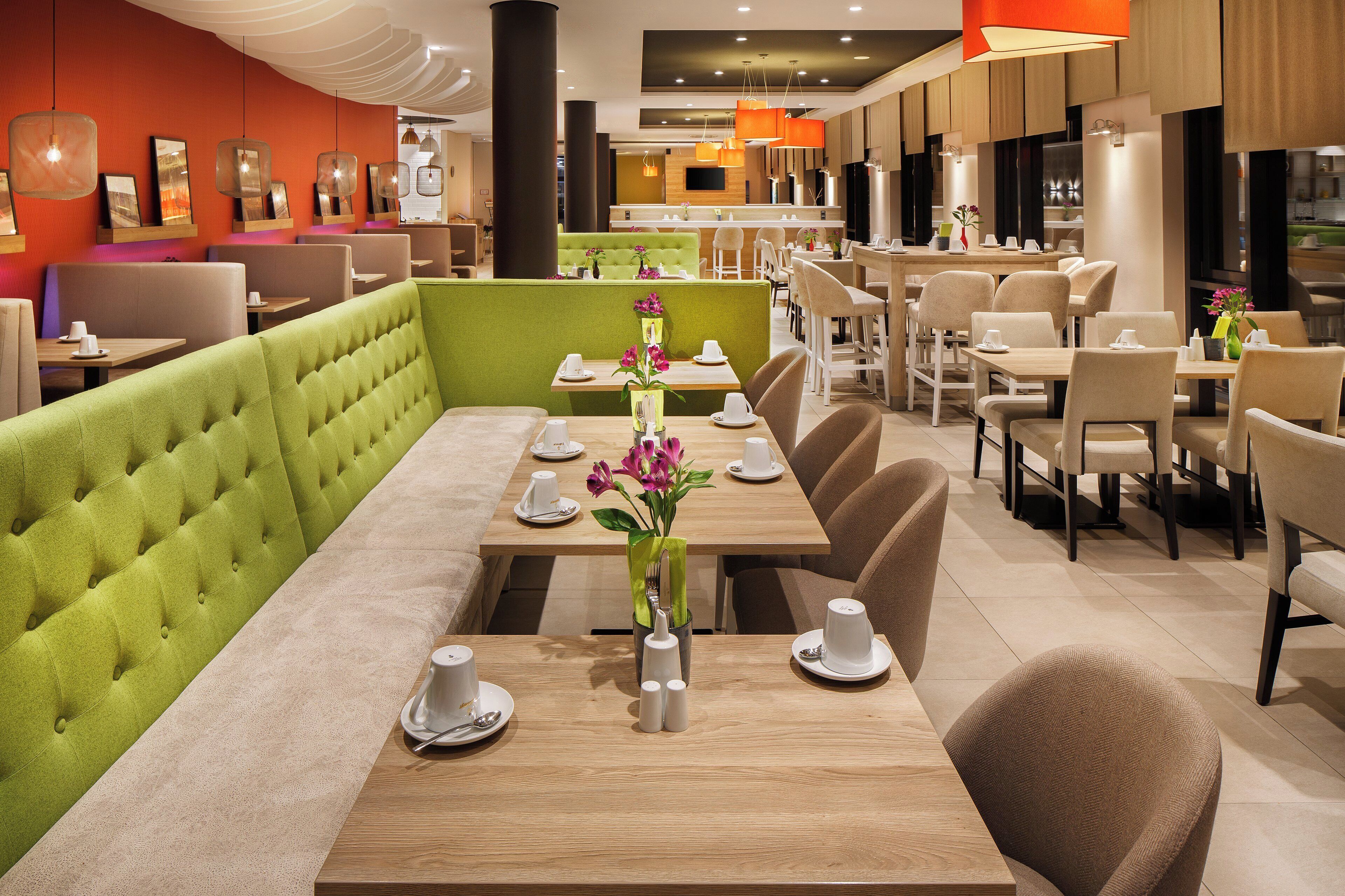 A restaurant with booths, tables, and chairs.