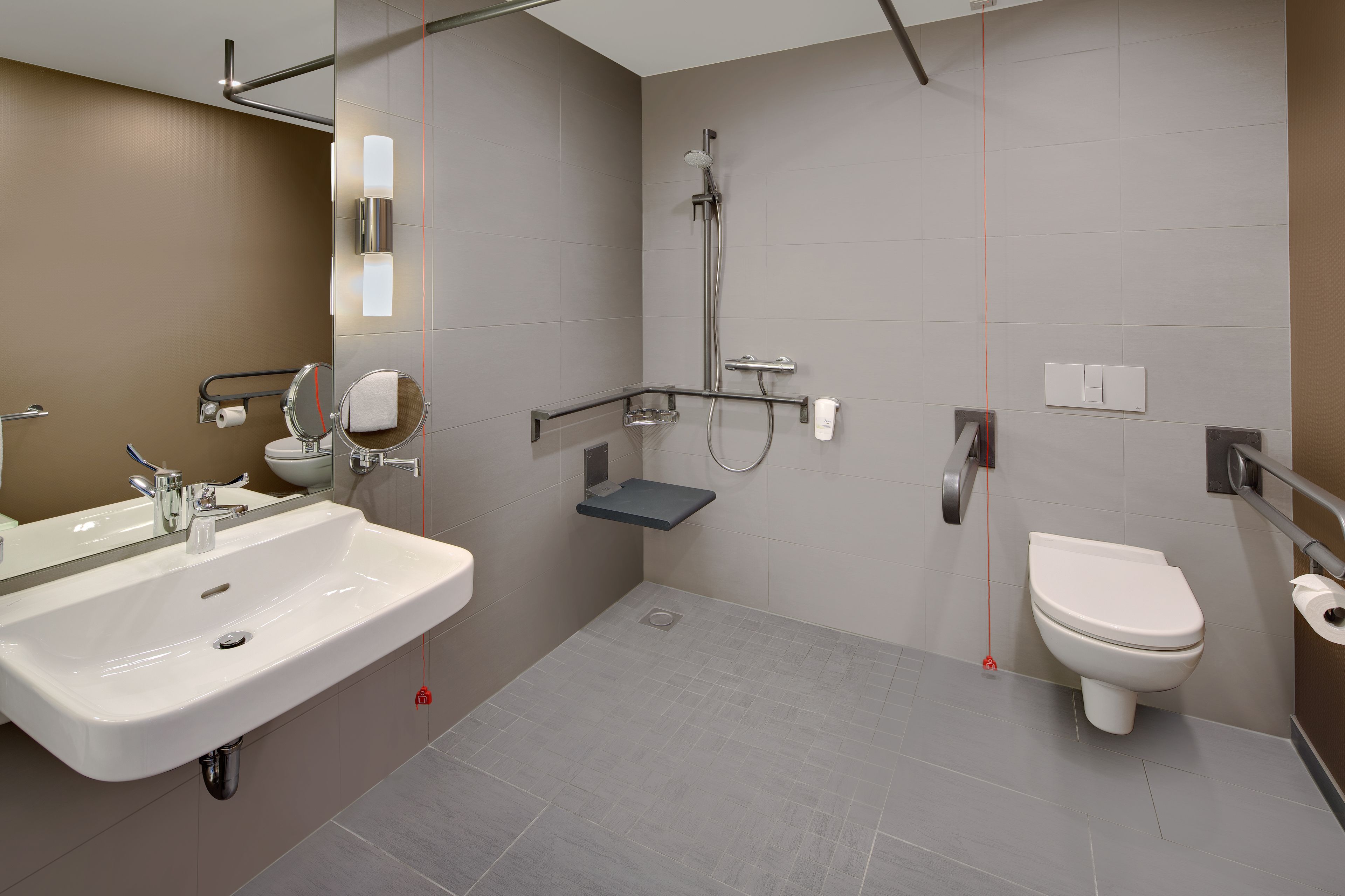 A modern bathroom with a sink, toilet, and shower.