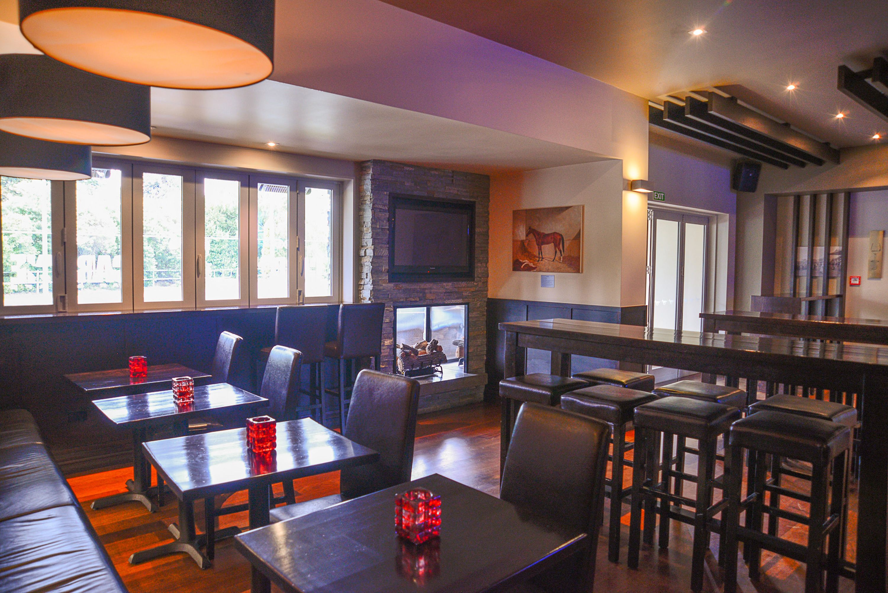 A restaurant with booths, tables, and a bar area.
