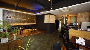 A restaurant interior with a wooden bar, seating area, and a counter. - Ekonomy Hotel Mokpo (Mokpo)