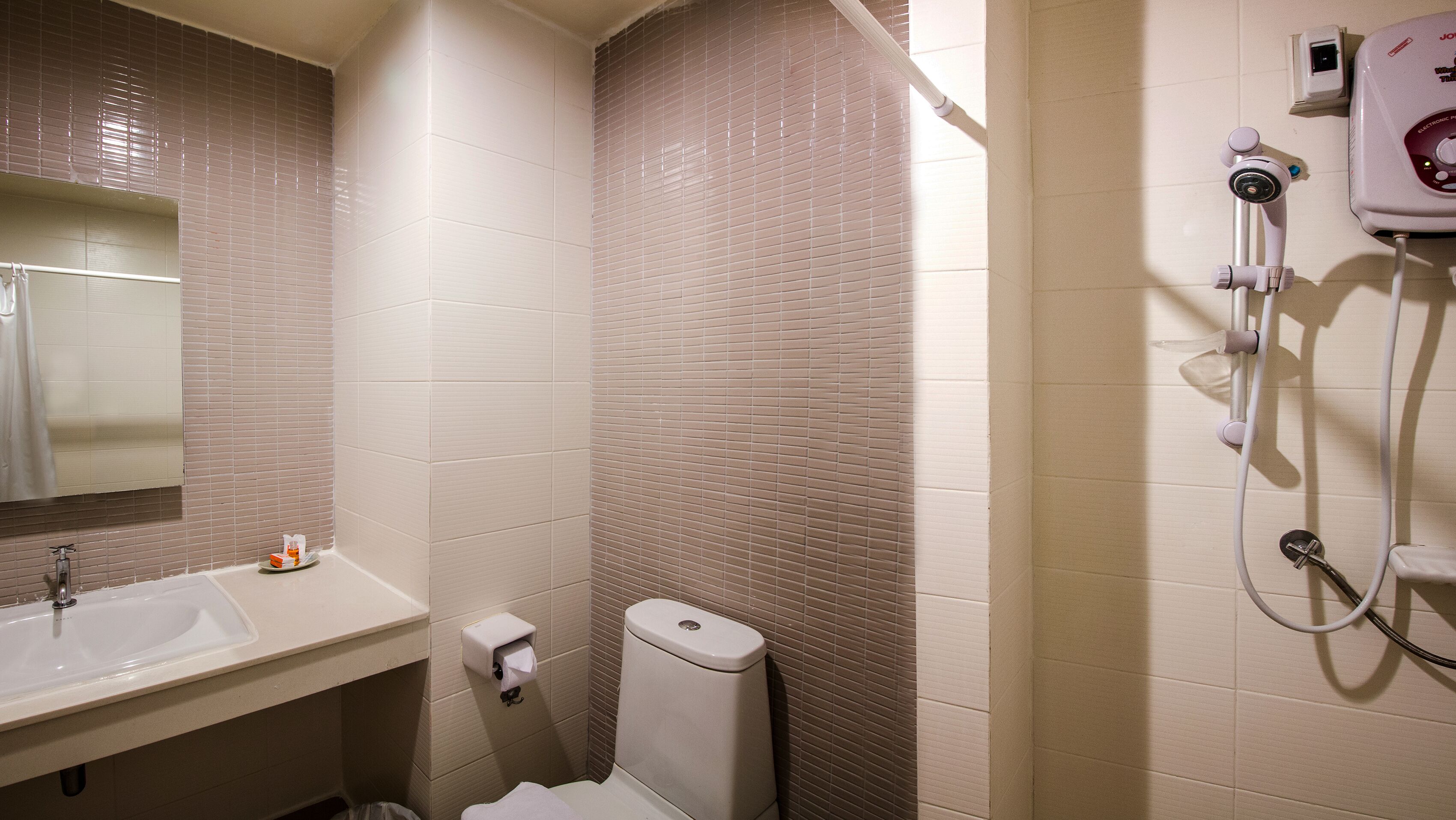 A bathroom with a sink, toilet, and shower.