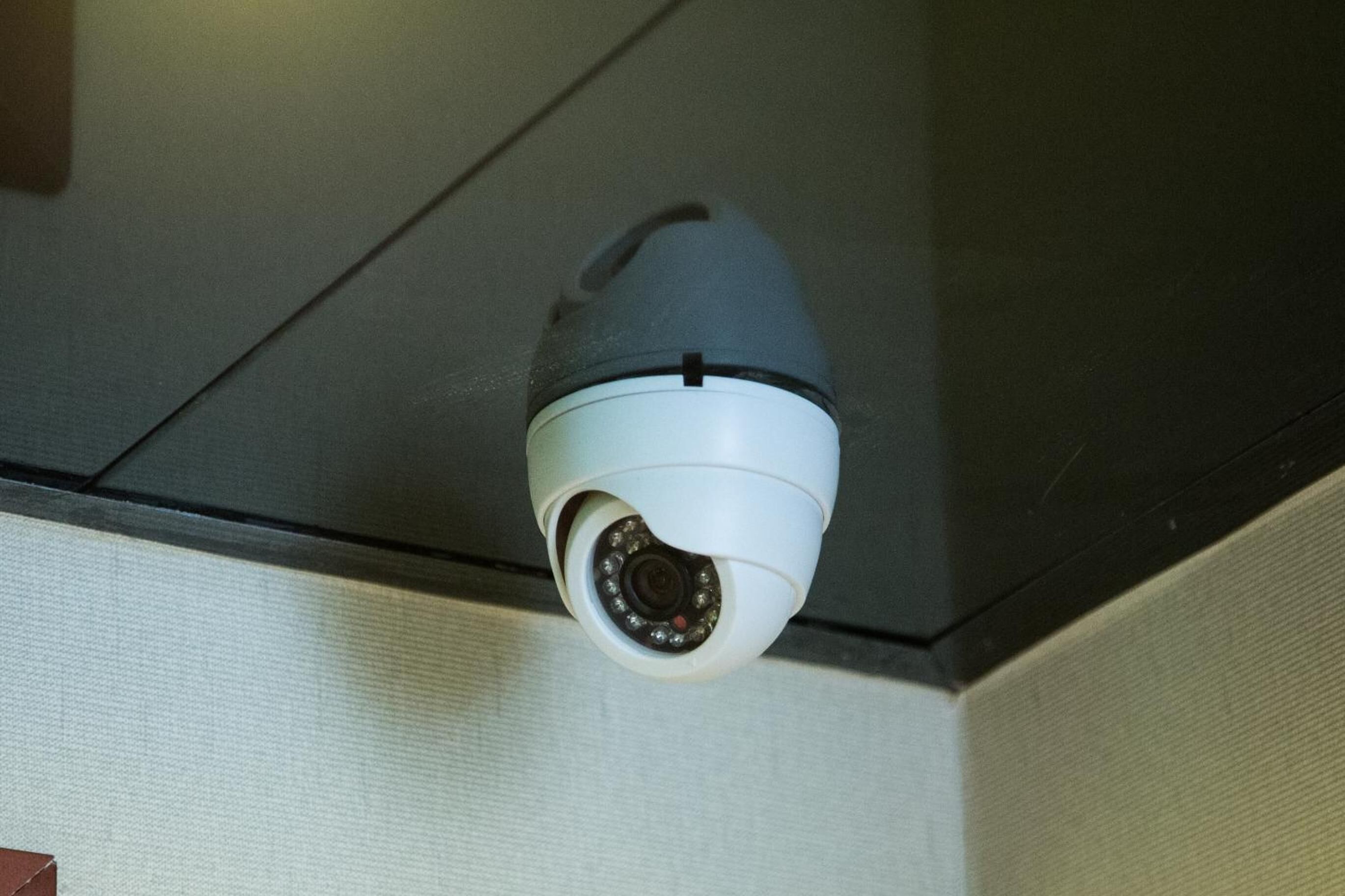 A security camera mounted on a ceiling.