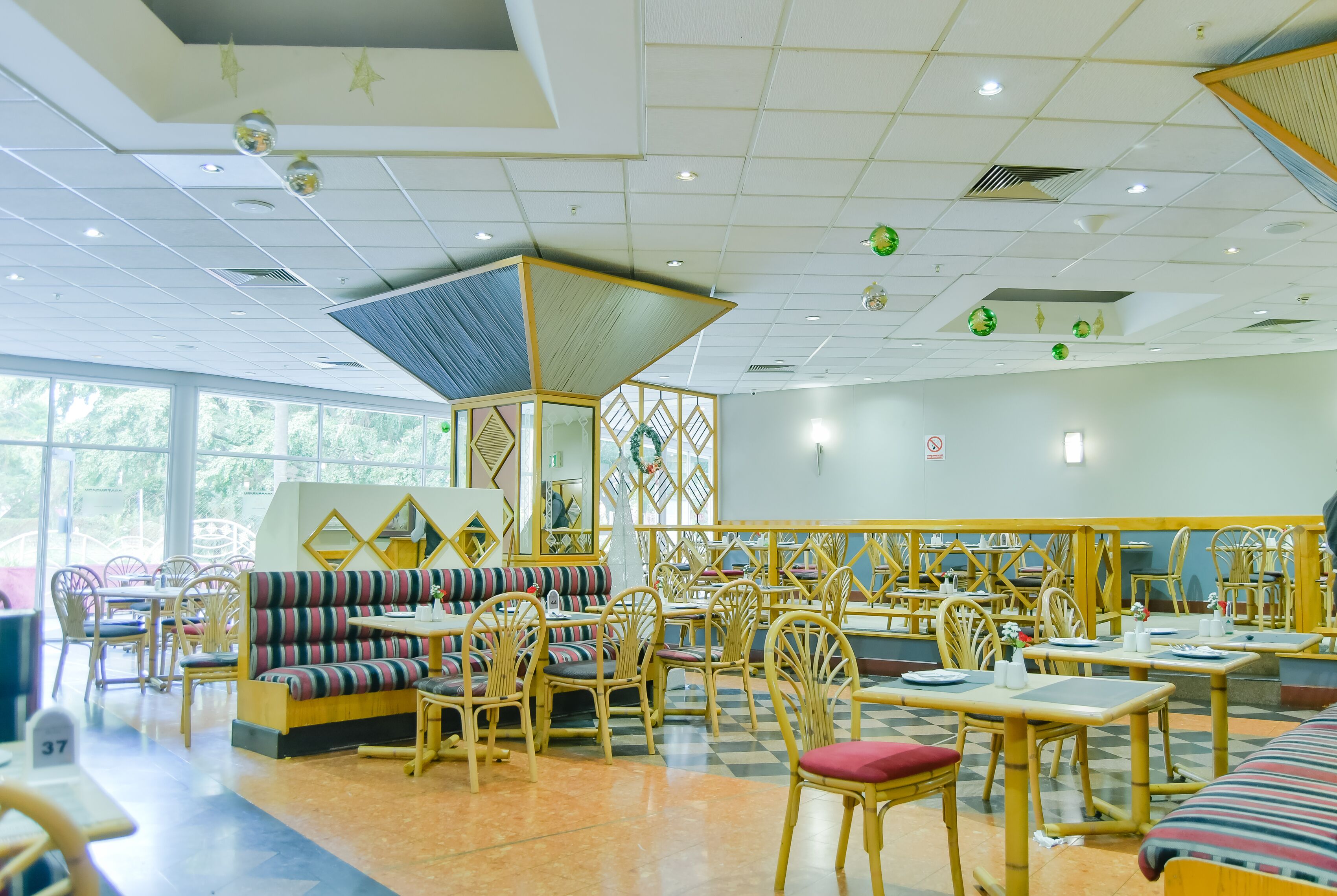 A restaurant with wooden furniture, a checkered floor, and large windows.