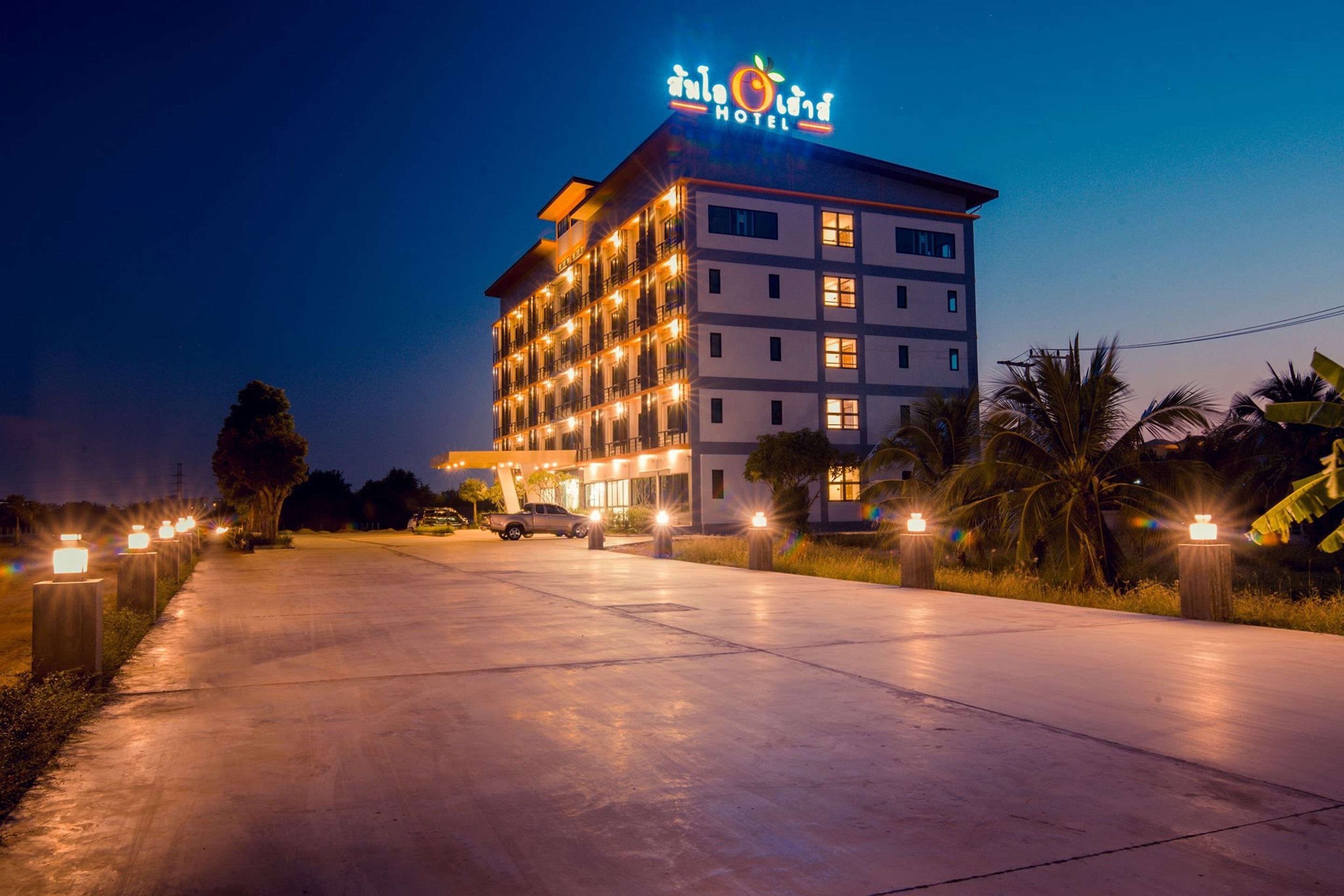 A multi-story hotel with a prominent sign at the top.