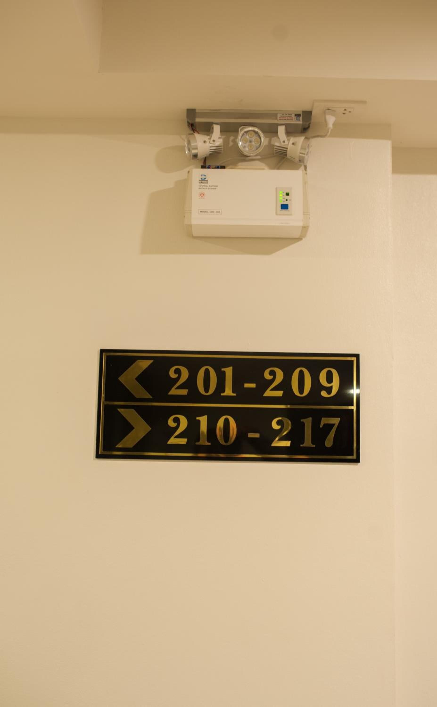 A hotel room door with a sign indicating room numbers 201-209 and 210-217.