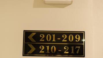 A hotel room door with a sign indicating room numbers 201-209 and 210-217.