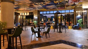 A spacious lobby with a variety of seating options, a ceiling mural, and large windows offering a view of the cityscape. - Seaden Valentine Resort & Spa - Adults Only - All inclusive (Manavgat)
