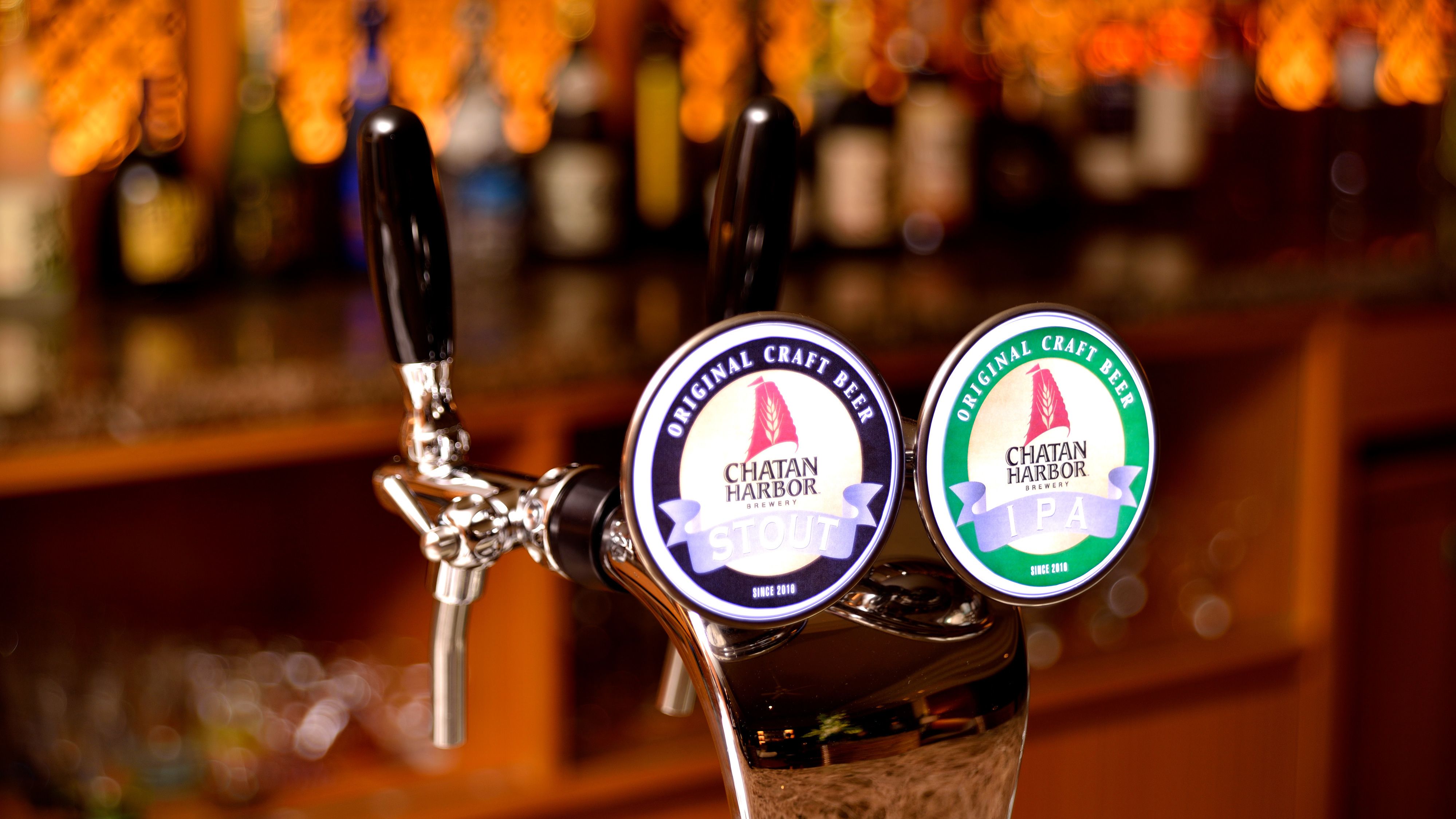 A tap with two beer labels, one for Chatan Harbor Brewery Stout and the other for Chatan Harbor Brewery IPA.