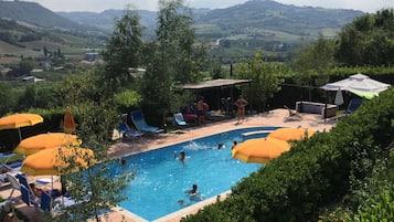 Seasonal outdoor pool, open 9:00 AM to 7:00 PM, pool umbrellas