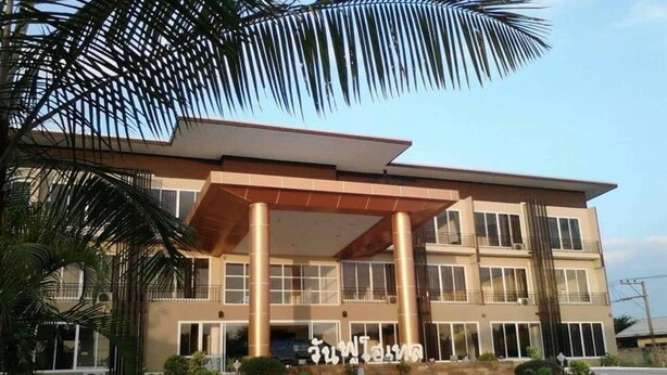 A modern building with a flat roof, large columns, and a covered entrance. - One Fu Hotel (Surin)