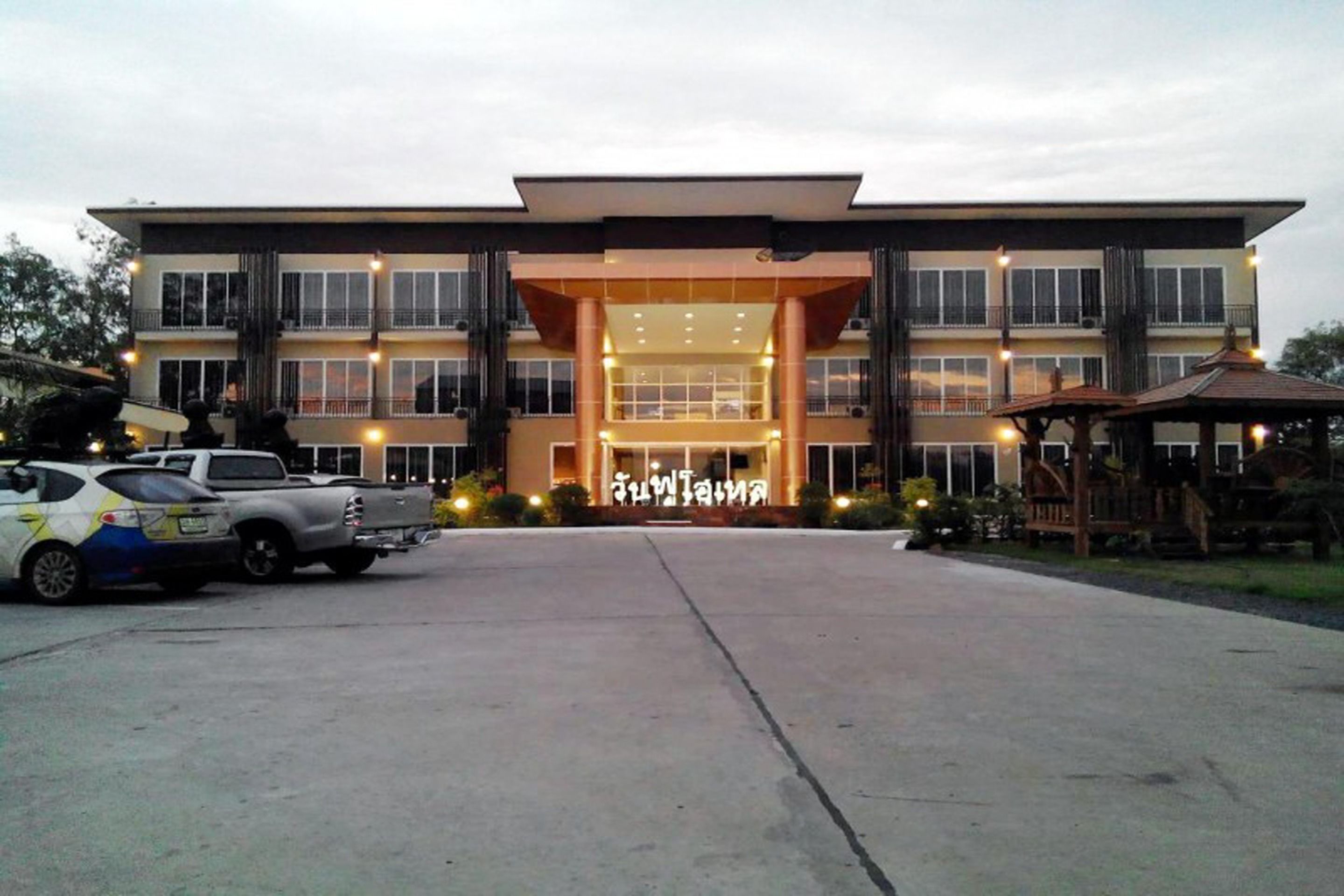 A modern hotel with a large entrance, multiple floors, and a well-lit facade.