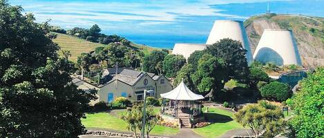 A coastal resort with a gazebo, landscaped gardens, and a view of the ocean.