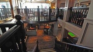 A multi-level interior with a staircase, wooden flooring, and a balcony area. - The White Hart Hotel by Greene King Inns (Buckingham)