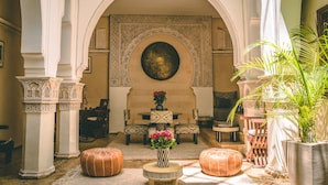 Een interieur met een centraal ziteiland, versierde zuilen en een grote decoratieve wand.