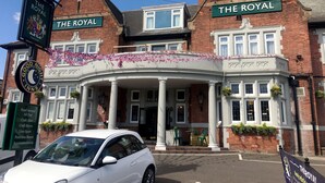 A traditional building with two signs reading "The Royal" and a sign for "Good Night Inns" with a moon and stars. - Royal Hotel By Greene King Inns (Scunthorpe)