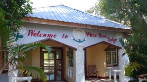 Um edifício com uma placa que diz "Welcome to White Rose Lodge".