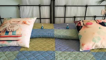 Restful retreat with a geometric-patterned bedspread and simple metal bed frame.