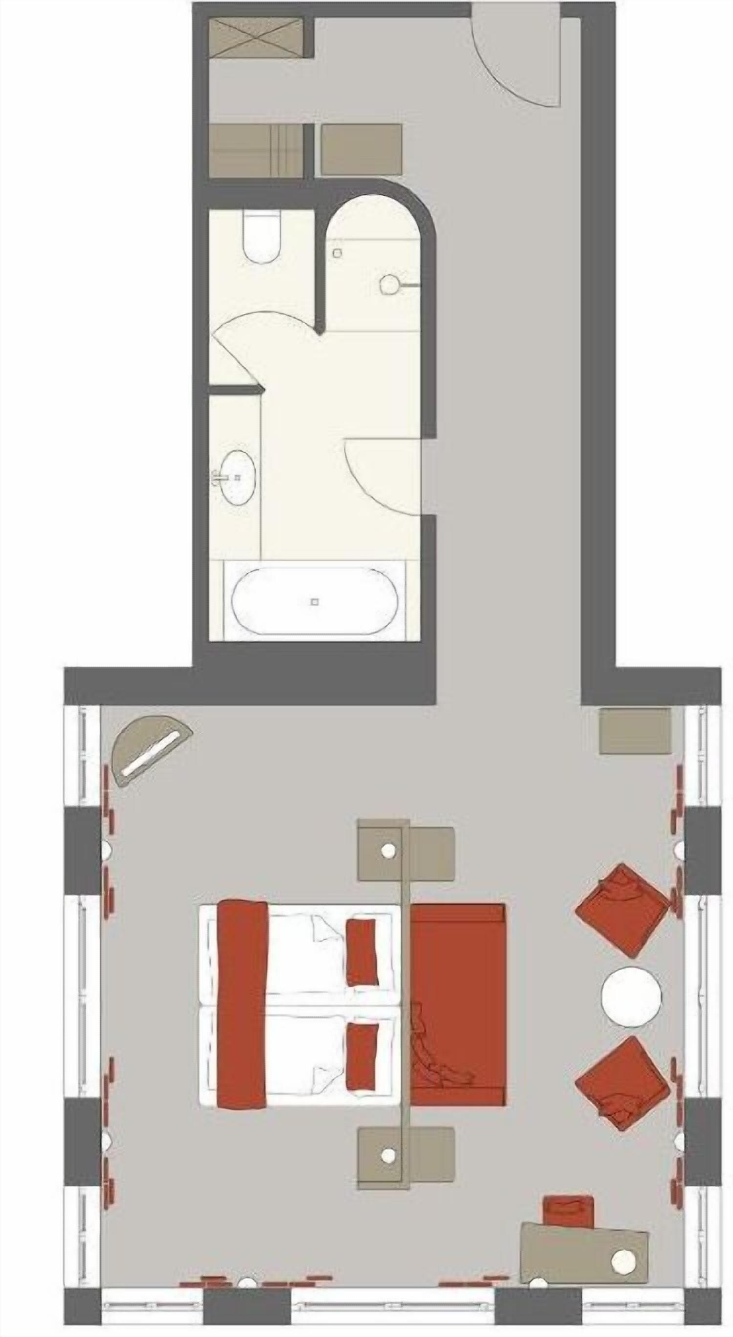 Ein Hotelzimmer mit Bett, Sitzecke und Bad.