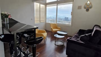 Deluxe Loft, City View | Living area | 30-inch flat-screen TV with cable channels, TV