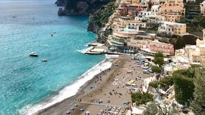 A coastal town with colorful buildings perched on a cliff overlooking the sea. - Palazzo Pascal - Amalfi Coast Luxury Experience (Scala)