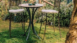 A table with two chairs under an olive tree, overlooking a mountainous town. - Palazzo Pascal - Amalfi Coast Luxury Experience (Scala)