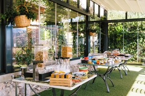 An outdoor buffet setup with various food items and a glass display case. - Palazzo Pascal - Amalfi Coast Luxury Experience (Scala)