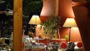 A restaurant interior with tables, chairs, potted plants, and lamps. - Primera Hacienda Hotel Boutique (La Serena)