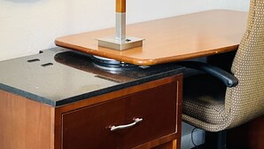 A hotel room with a desk, a chair, a television, a lamp, and a mirror. - Relax Inn Lawton (Lawton)