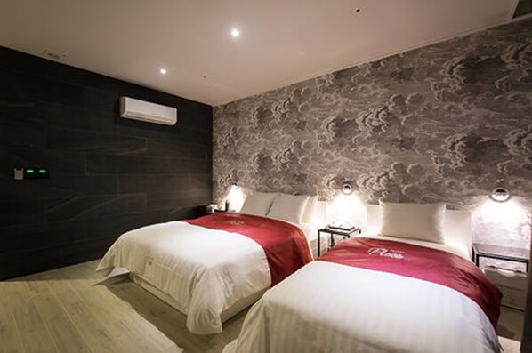 A hotel room with two beds, dark walls, and a textured ceiling. - Floce Hotel (Bucheon)
